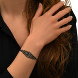 Bracciale morbido regolabile Babilonia - grigio